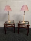A pair of contemporary bamboo and cane bedside tables with inset glass tops, along with a pair of