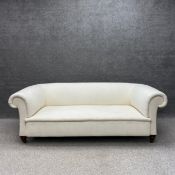 A Victorian three seater Chesterfield style sofa upholstered in an off white calico with a