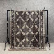 An Iranian woollen contemporary carpet with allover scrolling patterns over a mushroom ground