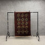 A Baluch woollen rug with all-over geometric designs in mustard and sapphire blue with iron red