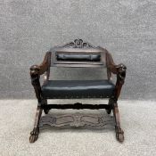 A late 19th century continental Renaissance style low walnut elbow chair having a carved cresting