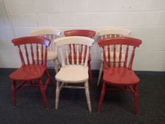 A set of six painted terracotta and cream farmhouse style spindle back chairs on turned and