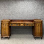 A large Regency twin pedestal drop centre walnut sideboard in three parts having a satinwood