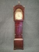 A Georgian mahogany 30 day longcase clock with brass finials and a shaped pediment, the enamel
