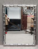 A mid to late 20th century moulded sheet metal simulated bamboo mirror. H.109 W.86cm.