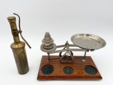 A set of steel scales with weights on an oak base, along with a brass Moore & Wright paraffin torch.