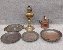 A late 19th/early 20th century Lampe Veritas brass oil lamp, along with a copper watering can and