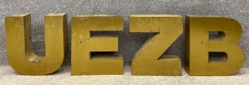 Four brass encased neon letters from a shop sign. H.36 W.31cm.