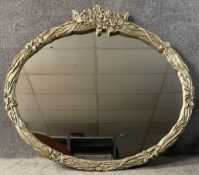A contemporary wall mirror in silvered foliate frame. H.109 W.126cm