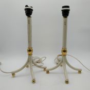 A pair of signed mid to late 20th century painted tubular metal and brass table lamps on four