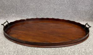 A late 19th century mahogany tray with twin brass handles. L.70 W.45cm