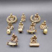 A late 19th/early 20th century brass Indonesian Gamelan orchestra figural set comprising nine