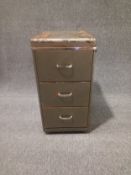 A mid century industrial style painted and hammered steel filing cabinet with three drawers and a