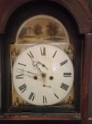 A Georgian mahogany 30 day longcase clock with brass finials and a shaped pediment, the enamel