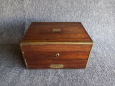 A 19th century rosewood vanity dressing box inset with brass plaques and trim, the hinged lid
