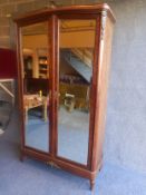 A C.1900 French walnut armoire having a shaped and crossbanded cornice with a gilt bronze shell