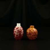 Two 19th century Chinese Qing dynasty Peking glass cameo carved snuff bottles each with overlaid