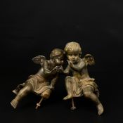 A pair of cast brass cherub or putti figures, probably clock mounts. H.16cm