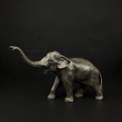 An early 20th century Japanese bronze bull elephant figure with a cast seal mark to the underside,