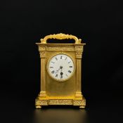 A large 20th century gilt metal carriage clock having a moulded handle over a breakfront cornice