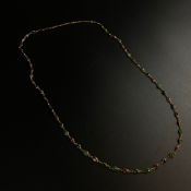 A gold plated necklace inset with jade cabochons and other stones.