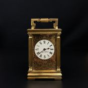 A 20th century brass Mappin & Webb carriage clock having a shaped swing handle above a moulded