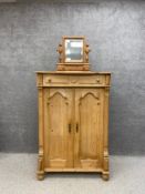 A 19th century Continental pine pier cabinet having a serpentine fronted top over a single carved