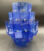 A mid-century Art Deco style pendant light having a stepped and faceted waterfall of applied