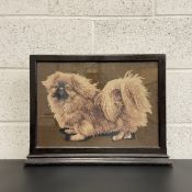 An early 20th century fire screen having a lacquered frame around a glazed needlework Pekinese dog