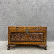 A mid 20th century Chinese camphor chest profusely carved with double happiness symbols flanked by