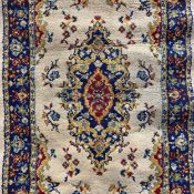 A small contemporary Persian style Kashan rug having a central scrolling medallion over a cream