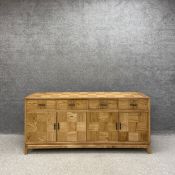 A contemporary oak parquetry sideboard having an all-over cross grained chequered pattern with