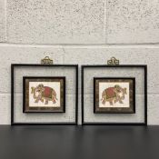 A pair of 20th century hand painted Indian elephants on silk in gilt scrolling borders floated in