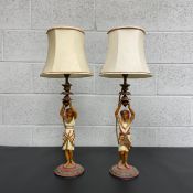 A pair of early 20th century cold painted spelter Egyptian figural lamps with shades. H.69cm (inc
