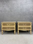 A pair of 20th century French style painted bedside cabinets each having a travertine marble top