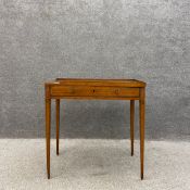 A George III satinwood side table, the top having a central marquetry inlaid paterae with an ebony