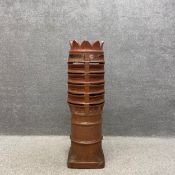A large Victorian salt glazed louvered chimney pot with an unusual flared and scalloped top having