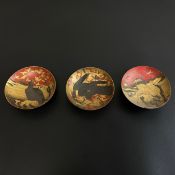 Three Japanese red lacquered narrow footed dishes, Meiji or Taisho period, with black lacquered