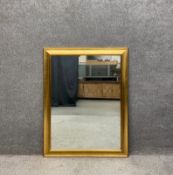 A contemporary gilt wall hanging mirror. H.118 W.92cm