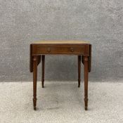 A George IV mahogany Pembroke table having a crossbanded and satinwood inlaid top with two drop