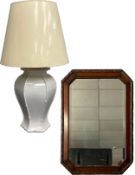 An early 20th century oak wall mirror with the original bevelled plate in a carved octagonal