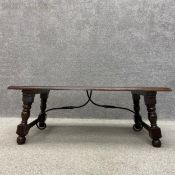 A 19th century style Spanish walnut coffee table with a moulded rectangular plank top raised on