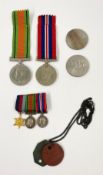 A collection of WWII defence medals and a Royal Air Force dog tag along with two later coins. Dia.