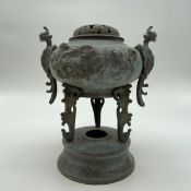 An archaistic patinated bronze Japanese censer having a pierced cover (with missing finial) over a