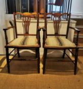 A pair of Edwardian mahogany elbow chairs on turned tapering supports with striped velour