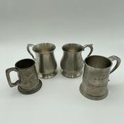 A collection of four Malaysian and English pewter tankards to include one Salenger, two Crown and
