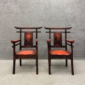 A pair of late 19th/early 20th century black and red lacquered Chinese yoke back armchairs each