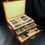 A stainless steel cutlery set by Arshia Germany in a fitted walnut case. H.19 W.45 D.33cm