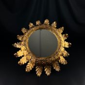 An early to mid 20th century gilt metal circular sunburst mirror of acanthus leaf design. W.50cm