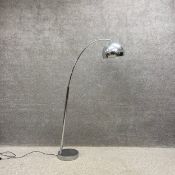 A contemporary floor standing chrome arc lamp on a round pedestal base. H.159.5cm